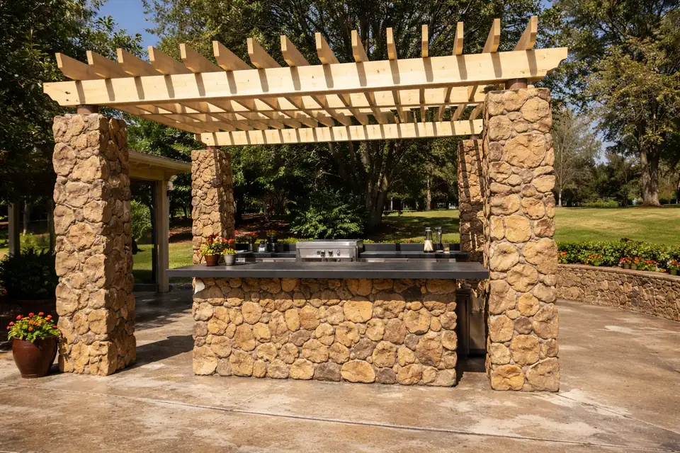 Hand-carved GFRC outdoor kitchen under a pergola in Plano Texas