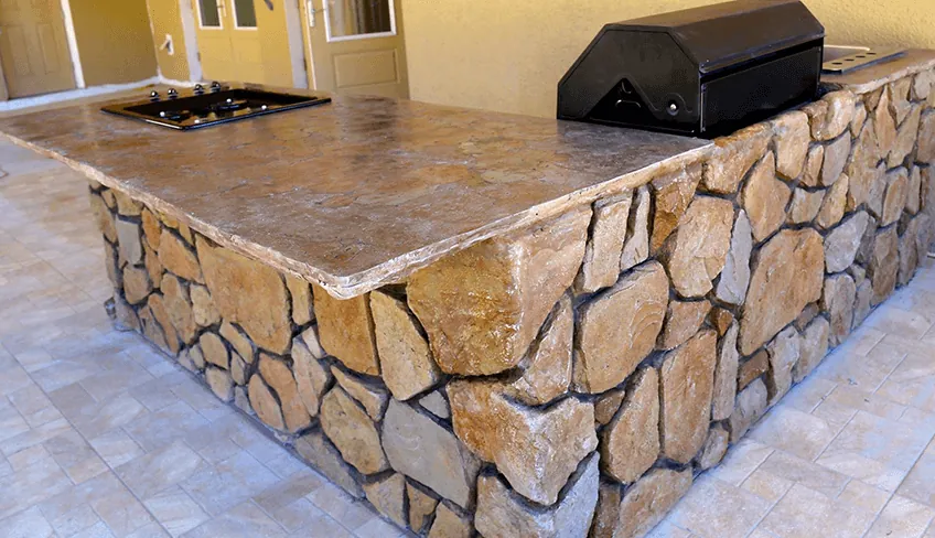 Custom L-shaped outdoor kitchen with built-in grill and GFRC countertops in Dallas-Fort Worth
