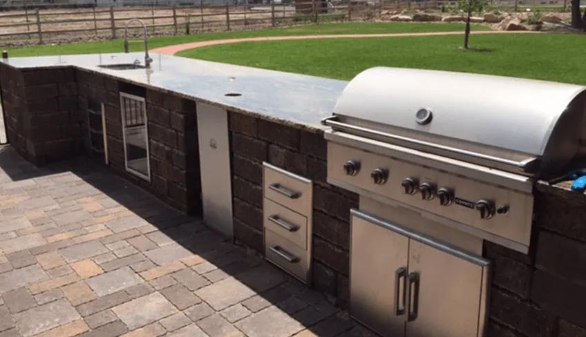 Hand-carved GFRC outdoor kitchen with built-in grill and bar counter in Arlington Texas