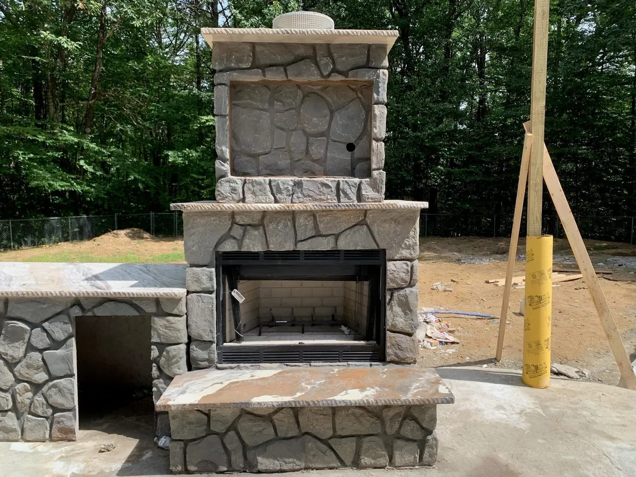 Hand-carved outdoor fireplace in a Dallas-Fort Worth backyard