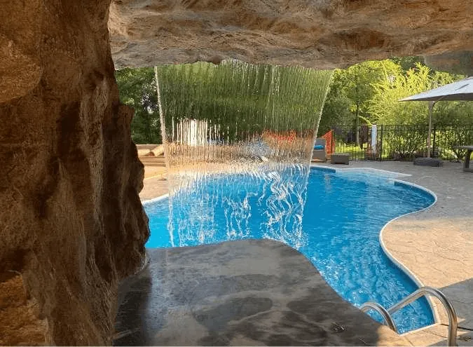 Luxurious custom water feature with cascading waterfall and professional landscaping