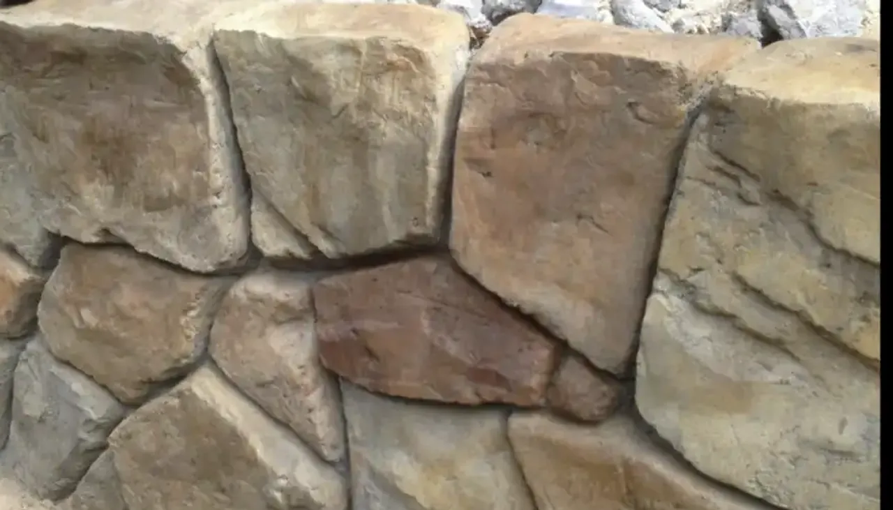 Hand-carved concrete retaining wall in Dallas Texas showing carved stone texture