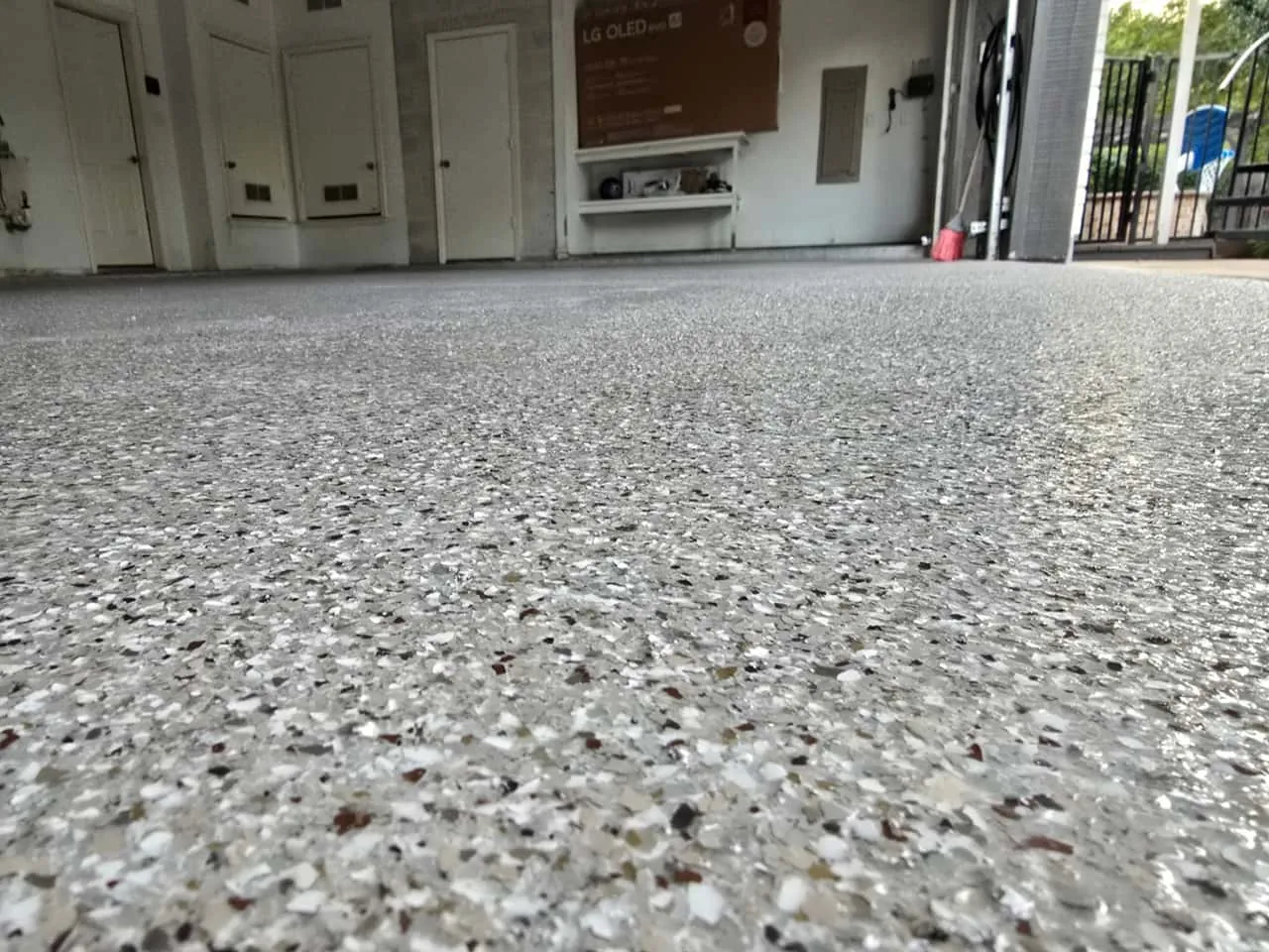Residential garage floor coating in Plano with gray white decorative flake epoxy finish