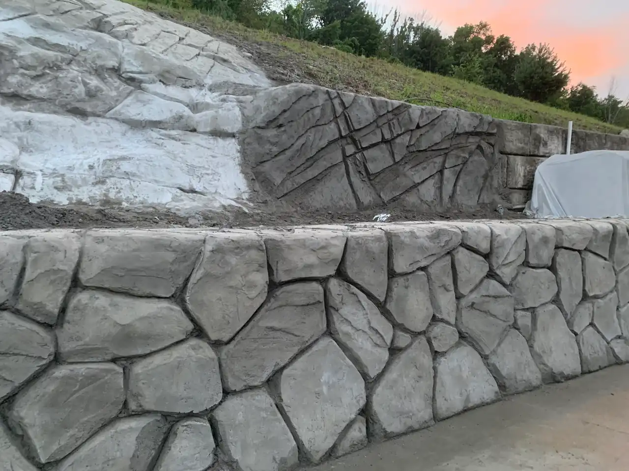 Carved stone retaining wall with hand-carved concrete finish in Flower Mound Texas