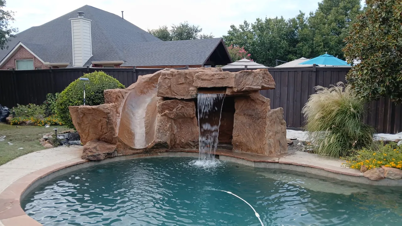 Pool grotto combo with a waterfall across the cave and a slide down the side of the rock