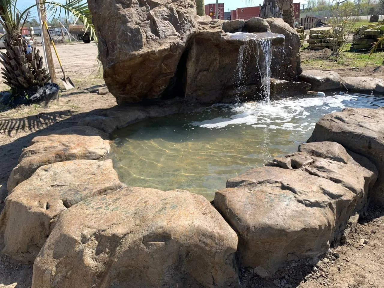Hand-carved GFRC pond waterfall with boulder features in Keller TX